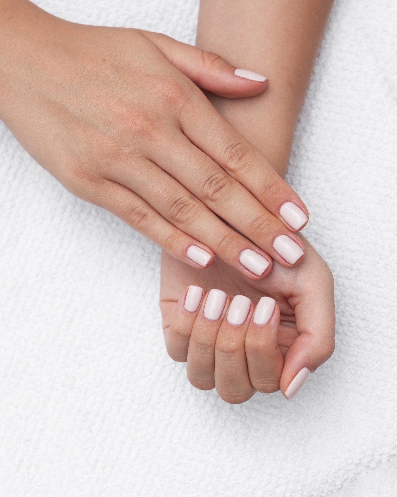 A clean, neutral manicure seen from above